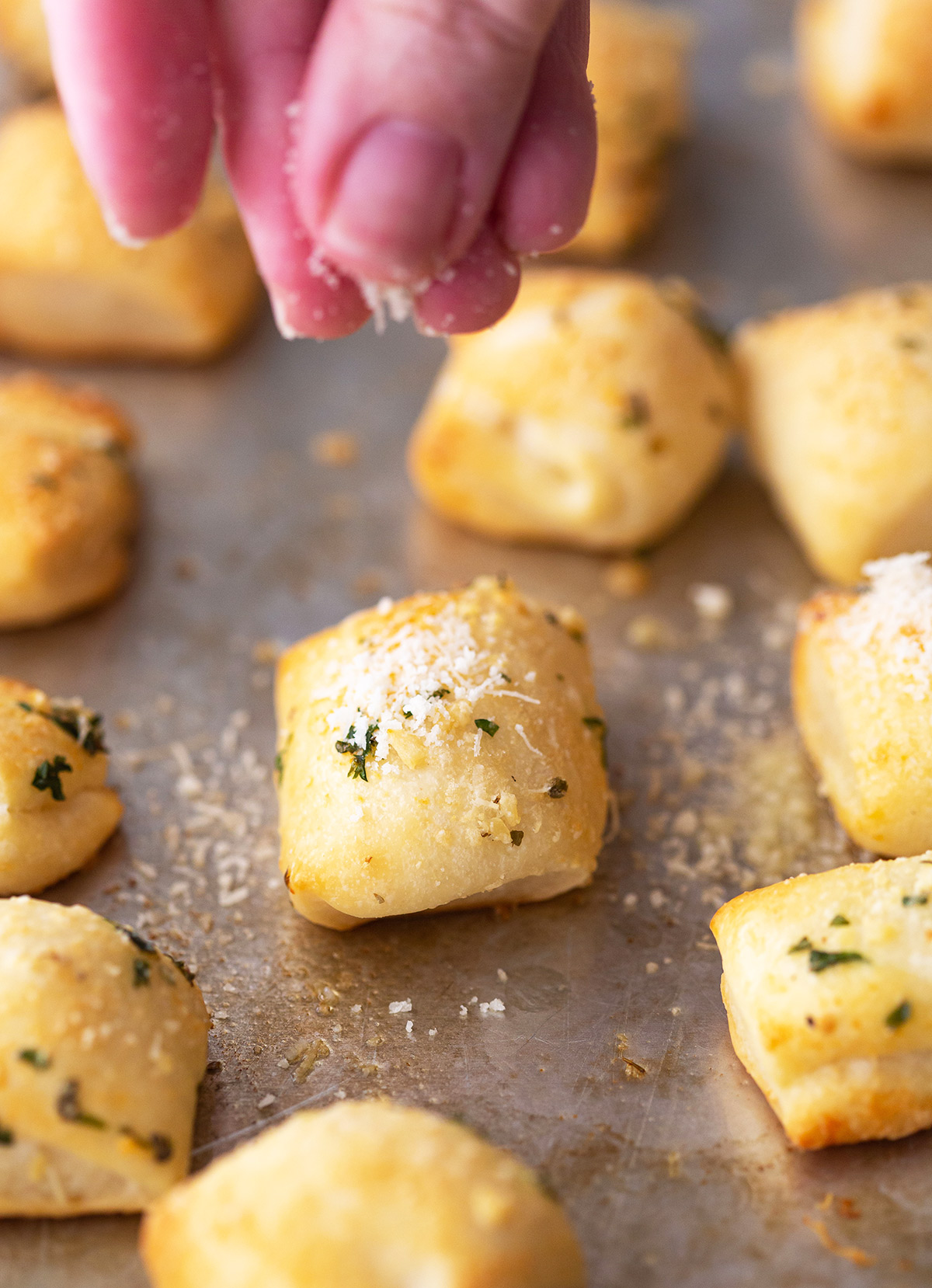 Sprinkling Parmesan on Bread Bites