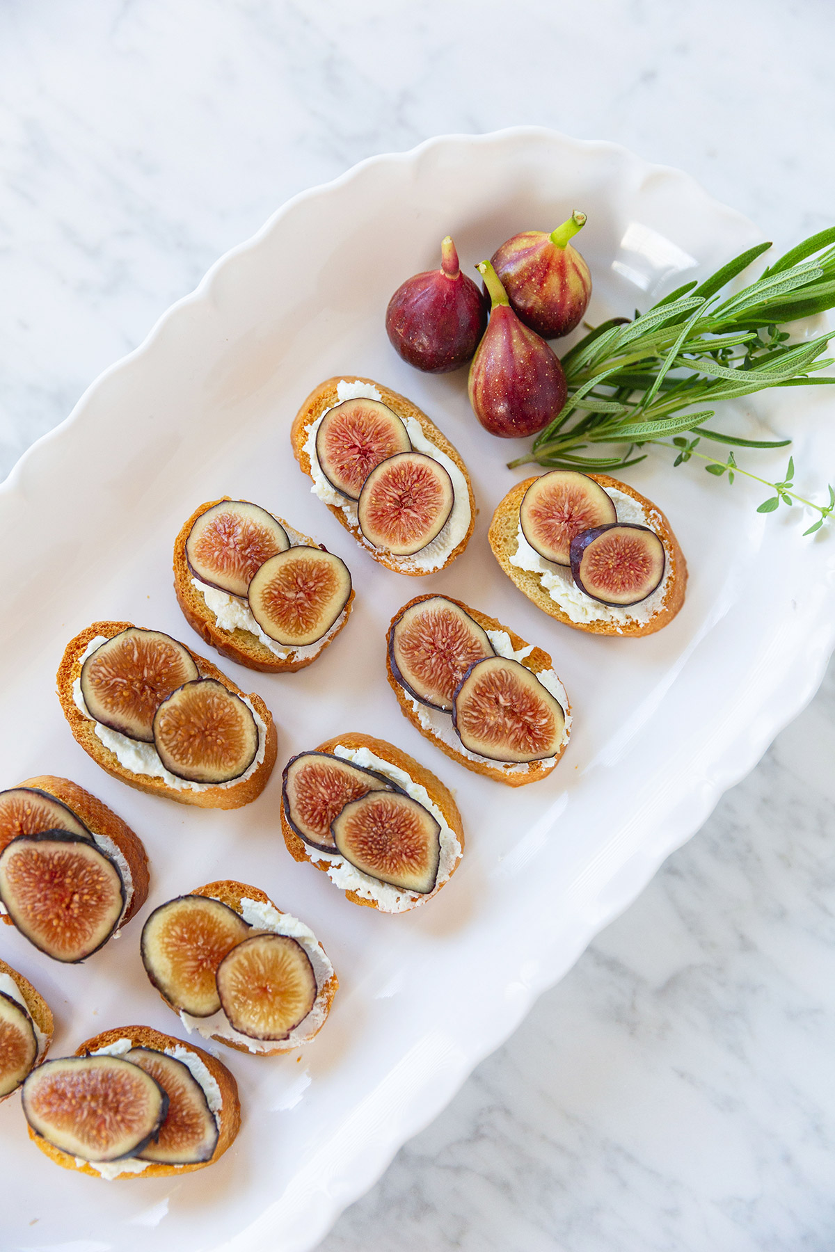 Sliced figs on goat cheese crostini toasts